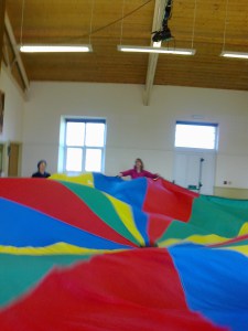 Twenty babies and toddlers are hiding under the parachute.