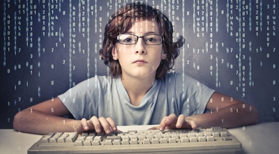 Child with computer keyboard with binary background