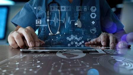 Doctor uses a tablet computer. Representation of AI in health care.