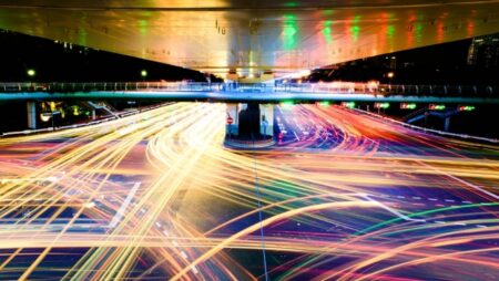 Long exposure image of a highway interchange, showing hundreds of trails left by headlights and brake lights.