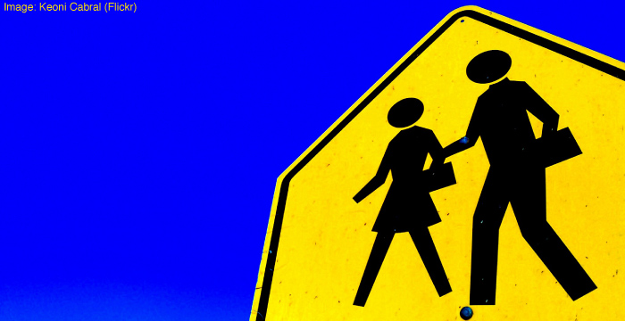 Road sign warning of people crossing the road. Image: Keoni Cabral (Flickr).