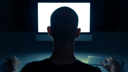 Man looking at computer in the dark