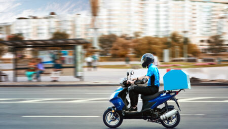 Moped delivery worker.