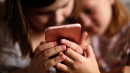 Children looking at mobile phone