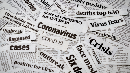 Coronavirus headlines cut out into a pile