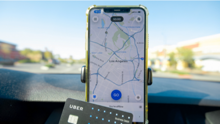 Uber debit card in front of smartphone open to map