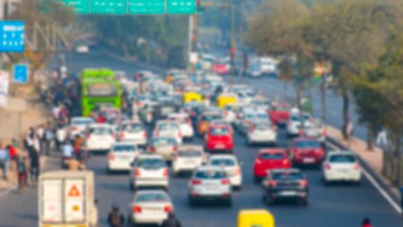 Defocused Picture of India Road Street with Cars, Mopeds and Rickshaws