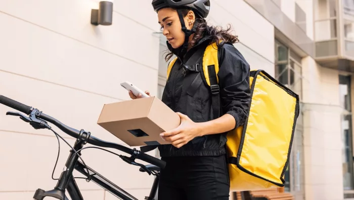 Woman holding package with bike