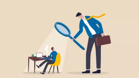 Cartoon depiction of micromanaging boss supervising worker with magnifying glass