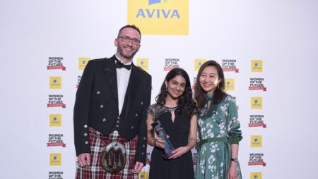 Sakshi Ghai holds a Women of the Future Award, standing in between two people