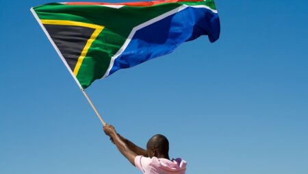 Person waving South African flag